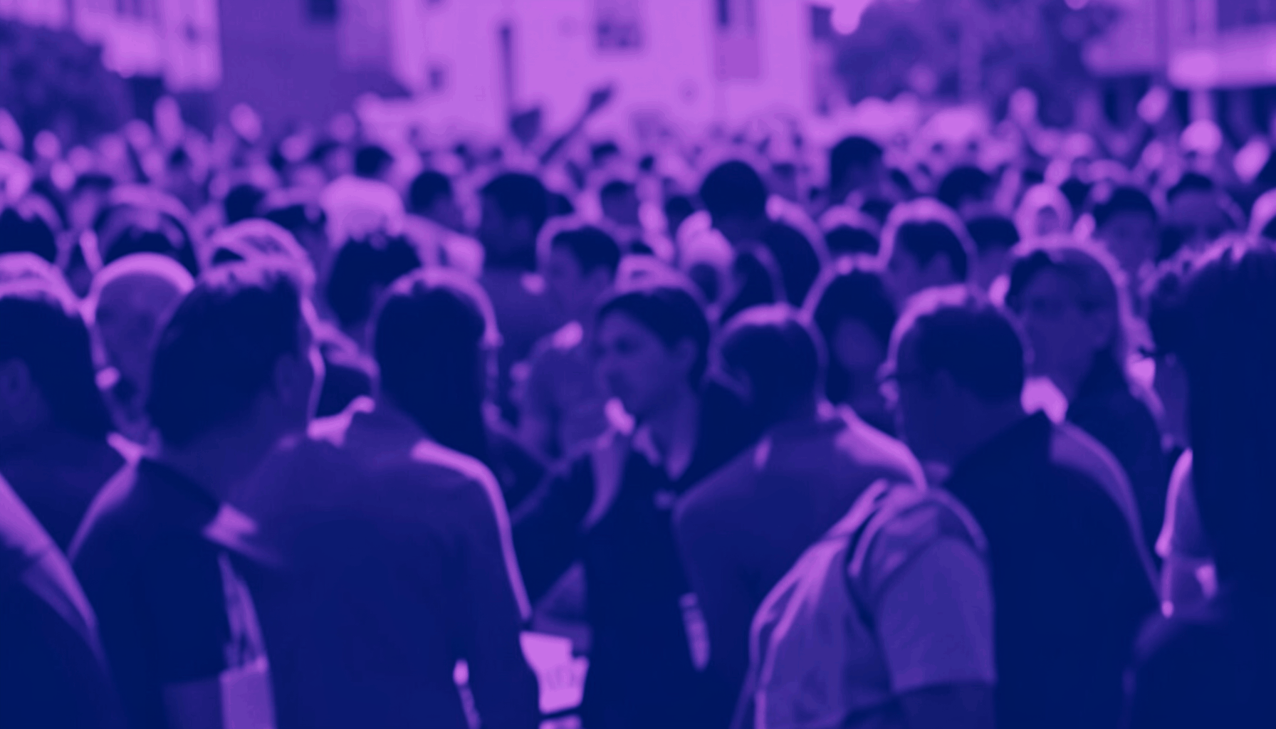 A duotone photograph in violet and navy showing an abstract crowd scene at a public gathering, with soft focus and a sense of collective energy.